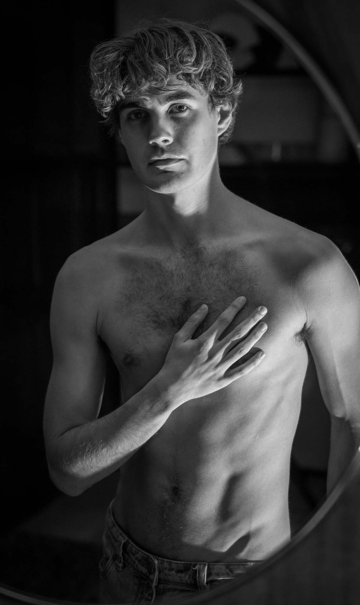 Fine art portrait — man framed in circular mirror